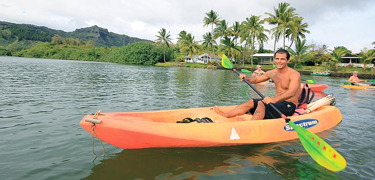alii-kayaks-guide-kauai-kayak a person riding on the back of a kayak in a body of water