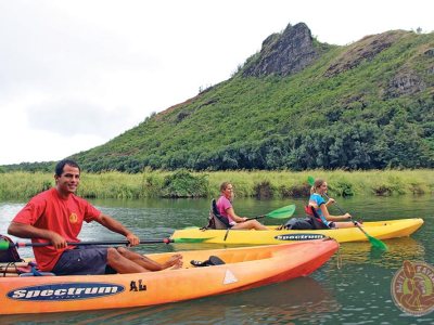 a group of people riding on the back of a boat in the water
