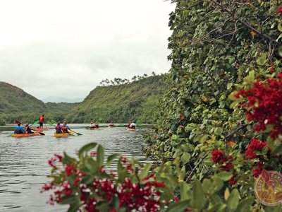 a group of people in a boat on a group of people in Wailua River