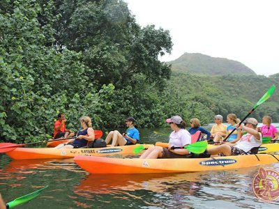 a group of people riding on the back of a boat